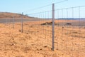 Barbed wire fence on dry land at west Australia Royalty Free Stock Photo