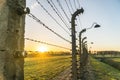 Barbed wire fence with lamps surrounding concentration camp in Auschwitz Birkenau, Poland Royalty Free Stock Photo