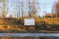 Barbed wire fence protects the danger zone. White sign board