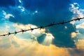 Barbed wire fence with silhouette sky and cloud Royalty Free Stock Photo