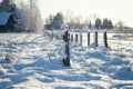 Barbed wire fence with snow covered ground Royalty Free Stock Photo