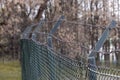 Barbed wire on a fence and steel lattice