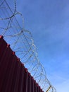 Barbed wire fence under blue sky Royalty Free Stock Photo