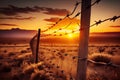 barbed-wire fence with a view of the sunrise over the horizon Royalty Free Stock Photo