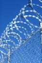 Barbed wire installation on top of concrete fence wall for heightened perimeter security Royalty Free Stock Photo