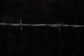 Barbed wire over dark grungy background Royalty Free Stock Photo