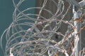 Barbed wire over the top of a chain link fence.