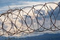 Barbed wire with overcast cloudy sky on the background Royalty Free Stock Photo