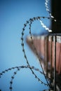 Barbed wire in the prison or on military base, close up perspective