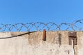 Barbed wire prison wall with blue sky background Royalty Free Stock Photo