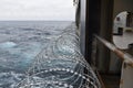 Barbed wire or razor wire attached to the ship hull, superstructure and railings to protect the crew against piracy attack.