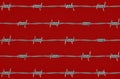 Barbed wire on red background Royalty Free Stock Photo