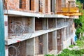 Barbed wire on an abandoned construction site made of reinforced concrete and brick structures Royalty Free Stock Photo