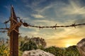 Barbed wire and rusty metal fence post in a field Royalty Free Stock Photo