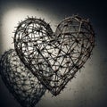 Barbed wire shaped into a heart form against a textured, gray wall Royalty Free Stock Photo