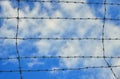Barbed wire and clouds background Royalty Free Stock Photo