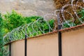 Barbed wire on a wall, security measure against thieves / intruders