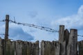 Barbed wire on wooden fence Royalty Free Stock Photo