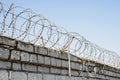 Barbed wire wound to the top of a brick fence