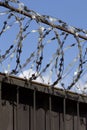 Barbed wire wound to the top of a fence