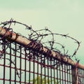 Barbed wires against blue sky