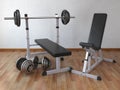 Barbell bench with weight dumbbells in the home.