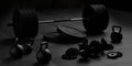 Barbell, kettlebells and dumbbells with black plates on floor on black mats background, sport, fitness, exercise or weightlift Royalty Free Stock Photo