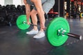 Barbell squats. Man trains in the gym, lifting a barbell. Close up. The concept of fitness and wellness Royalty Free Stock Photo