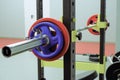 A barbell with weights for fitness lies in the gym on an adjustable rack Royalty Free Stock Photo