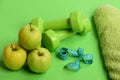 Barbells by green apple. Healthy lifestyle and low calorie food