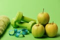 Barbells near juicy green apple. Sports and healthy regime equipment Royalty Free Stock Photo