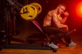 Barbells workout. Athletic guy standing with barbell, workout in gym. Bodybuilder athletic man with six pack, perfect Royalty Free Stock Photo