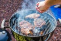 Barbeque with delicious fresh Rib eye and Entrecote which are frying on a grid over a fire
