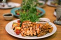 Barbeque grilled chicken breast and fried potato chip serving with fresh salad