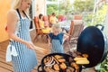 Barbeque party in the garden with mom and her daughter at the grill