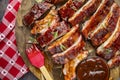 Barbeque ribs sliced on round wooden cutting board Royalty Free Stock Photo