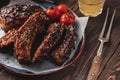 Barbeque spicy ribs served on the wooden table. Smoked Roasted p