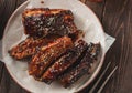 Barbeque spicy ribs served on the wooden table. Smoked Roasted p