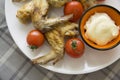 Barbeque wings and fresh tomatoes Royalty Free Stock Photo