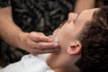 Barber closing mans pores with alum stone. Traditional ritual of after shaving the beard with alum stone. Client getting his face Royalty Free Stock Photo