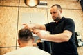 Barber cutting hair with scissors Royalty Free Stock Photo