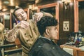 Barber Cutting Hair to a Client at Barber Shop Royalty Free Stock Photo