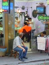 Barber cutting mans hair in hairdresser shop Royalty Free Stock Photo