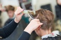 Barber or hair stylist at work. female hairdresser cutting child hair