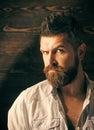 Barber and hairdresser salon. Man with beard and mustache on wooden background. Haircut of bearded man, archaism Royalty Free Stock Photo