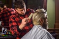 Barber hairstyle barbershop. Hipster getting haircut. Sharp object near face and squirming distracts person holding it Royalty Free Stock Photo