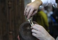 Barber hands cutting customer hair with scissors and comb Royalty Free Stock Photo