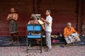 Barber with his customers waiting at the street of Varanasi/Benaras, India