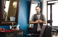 Barber invites to have seat on chair at barbershop