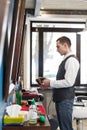 Barber invites to have seat on chair at barbershop